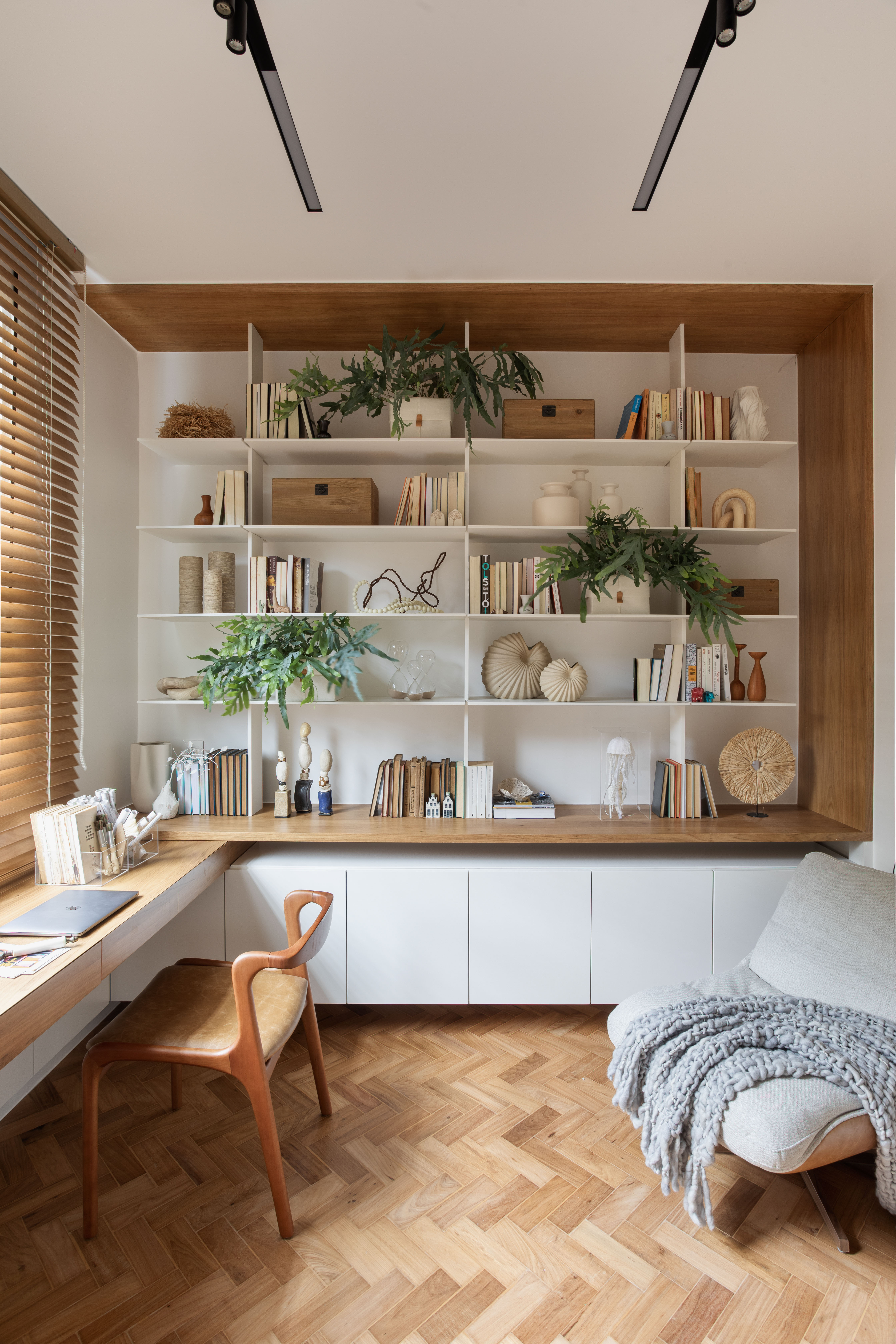 Apartamento de 110 m² ganha décor aconchegante com clima carioca. Projeto de Rafael Ramos. Na foto, home office com estante suspensa.