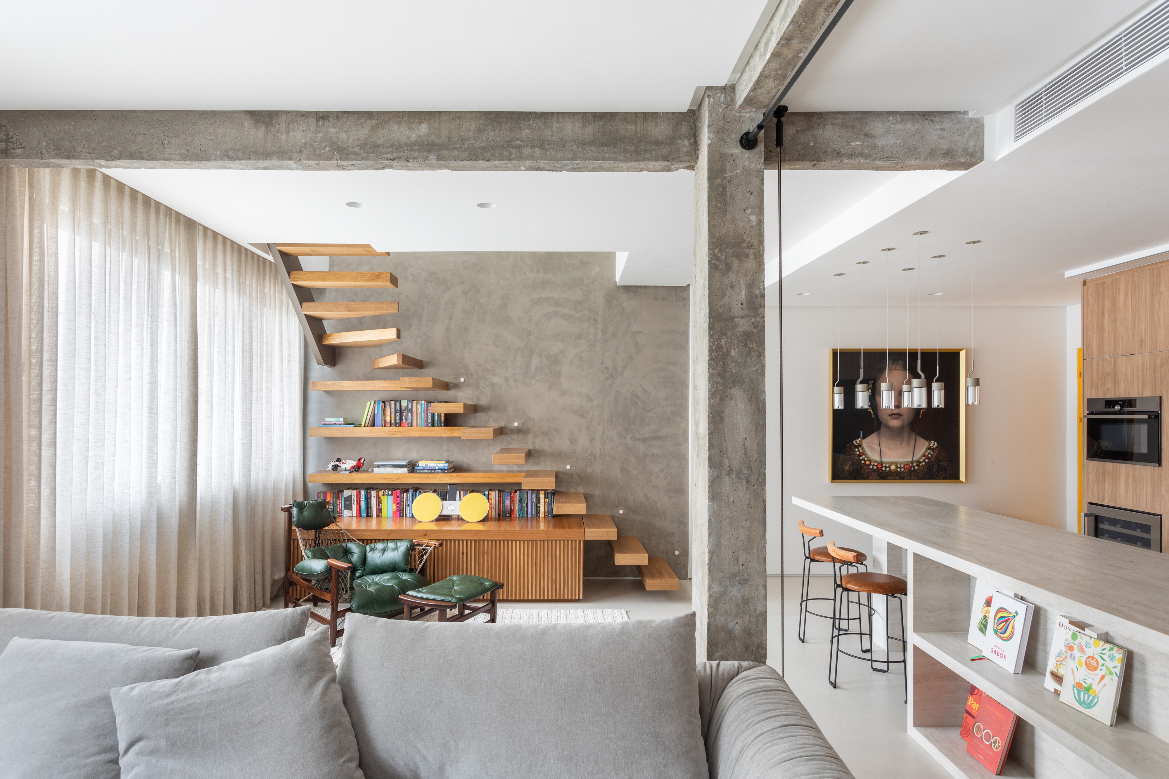 Cobertura ganha closet, piscina e espaço gourmet em 149 m². Projeto de Rodrigo Barbosa. Na foto, sala com viga aparente, escada e cozinha.