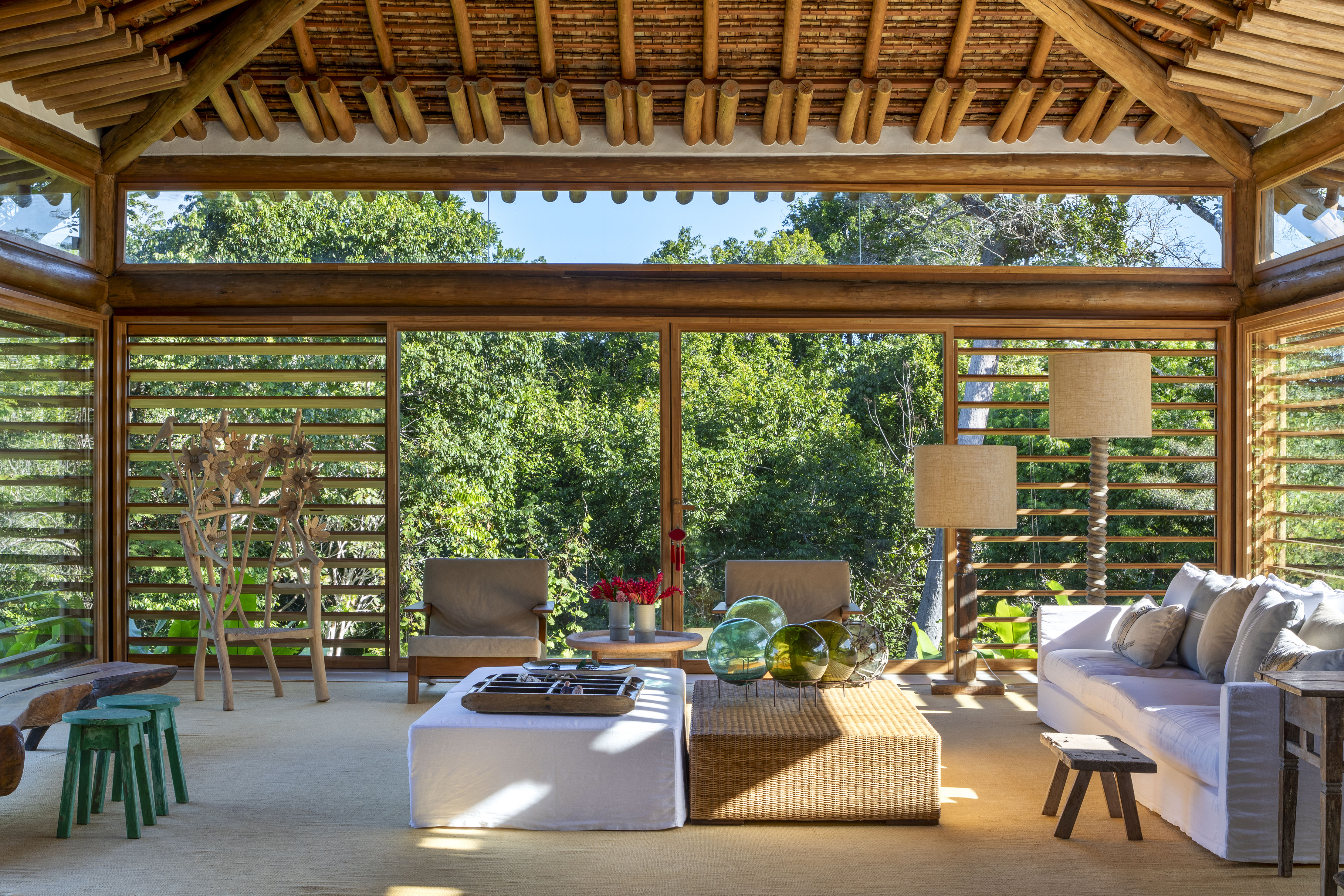 Deques de madeira organizam casa em Trancoso composta por oito módulos, Projeto de David Bastos. Na foto, varanda com brise e jardim.